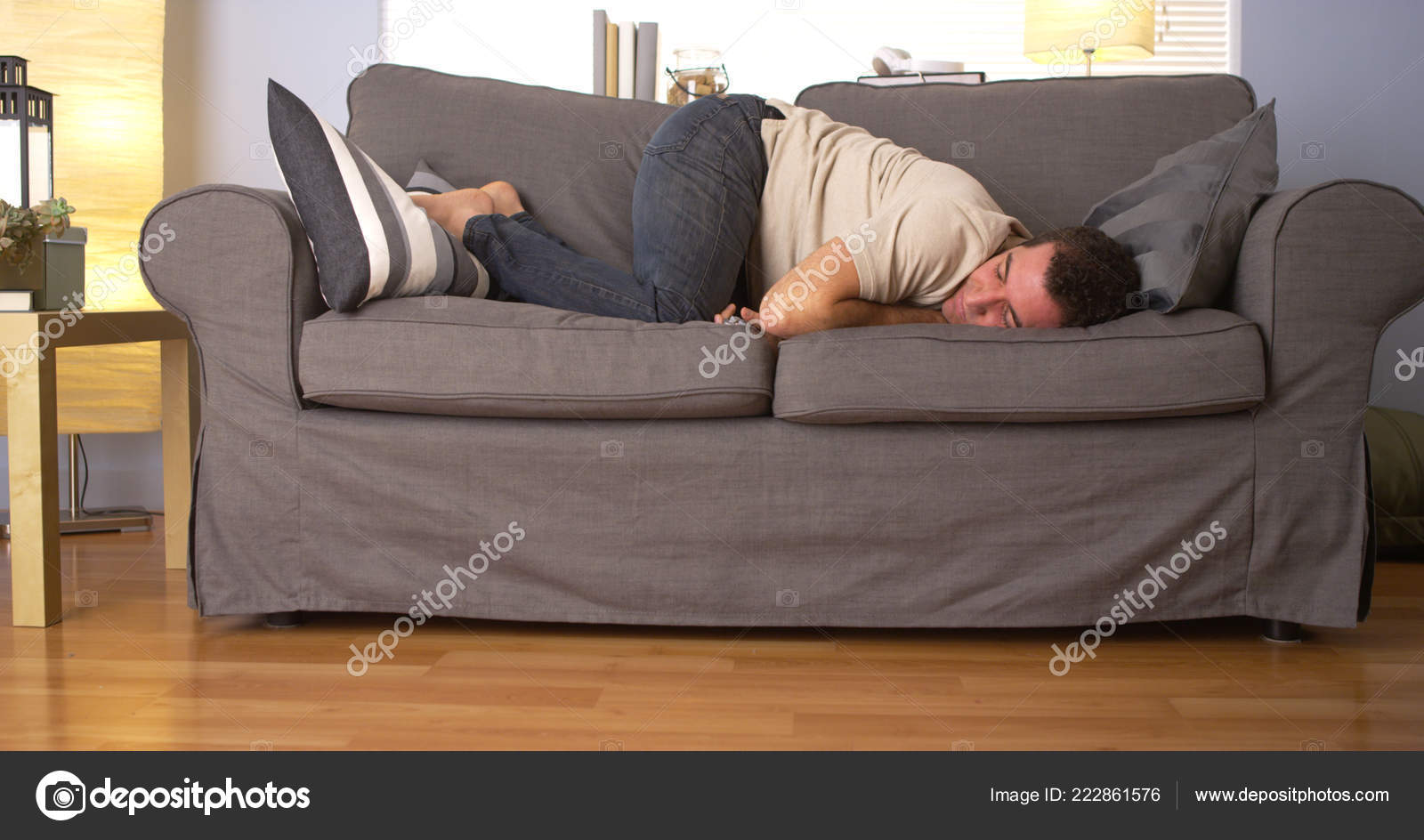 depositphotos 222861576 stock photo man trying sleep couch